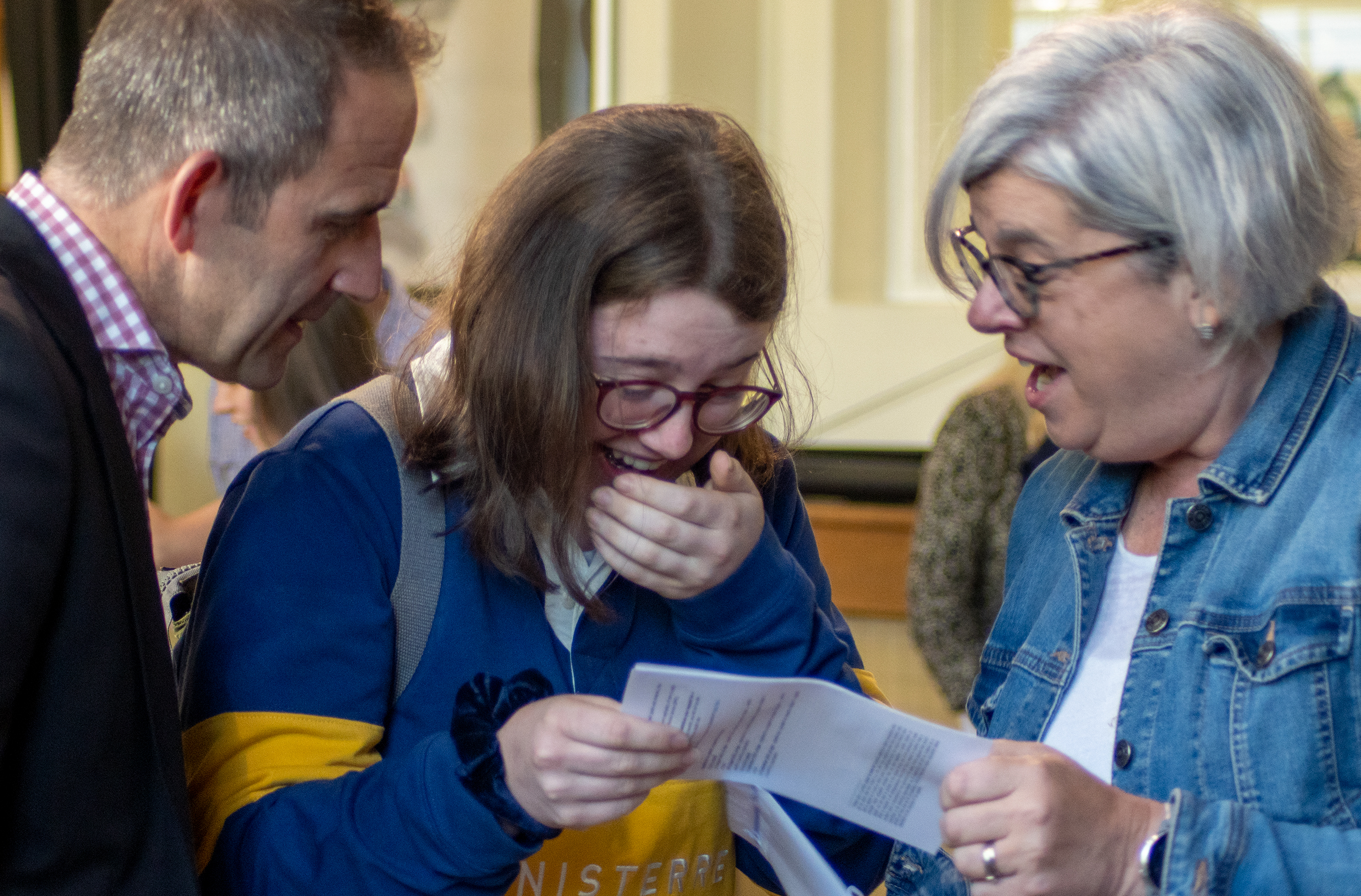 Abi Holden with her family as she reads her results